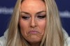 United States' Lindsey Vonn grimaces during a press conference by the U.S. ski team at the 2026 Winter Olympics, in Cortina d'Ampezzo, Italy, Tuesday, Feb. 3, 2026. (AP Photo/Fatima Shbair)