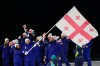 Diana Davis, left, and Luka Berulava, flag bearers of Georgia, lead Georgia athletes as they walk during the Olympic opening ceremony at the 2026 Winter Olympics, in Milan, Italy, Friday, Feb. 6, 2026. (AP Photo/Lee Jin-man)
