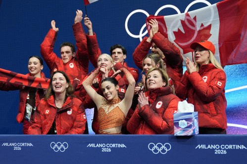 Madeline Schizas, center, of Canada reacts to her scores after competing during the figure skating women's team event at the 2026 Winter Olympics, in Milan, Italy, Friday, Feb. 6, 2026. (AP Photo/Stephanie Scarbrough)