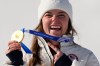 United States' Breezy Johnson shows her gold medal in the alpine ski women's downhill race, at the 2026 Winter Olympics, in Cortina d'Ampezzo, Italy, Sunday, Feb. 8, 2026. (AP Photo/Andy Wong)