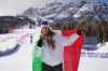 Italy's Sofia Goggia shows her bronze medal for an alpine ski women's downhill race, at the 2026 Winter Olympics, in Cortina d'Ampezzo, Italy, Sunday, Feb. 8, 2026. (AP Photo/Andy Wong)
