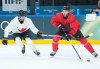Canadian forward Connor McDavid, right, drives past teammate Seth Jarvis during practice at the 2026 Milan Cortina Winter Olympics in Milan on Sunday, Feb. 8, 2026. THE CANADIAN PRESS/Nathan Denette