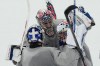 United States goalkeepers Connor Hellebuyck, Jake Oettinger, and Jeremy Swayman, gather on the ice during men's ice hockey practice at the 2026 Winter Olympics, in Milan, Italy, Sunday, Feb. 8, 2026. (AP Photo/Carolyn Kaster)