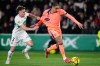 Barcelona's Raphinha, right, vies for the ball Elche's Adria Pedrosa during a Spanish La Liga soccer match between Elche and Barcelona in Elche, Spain, Saturday, Jan. 31, 2026. (AP Photo/Jose Breton)