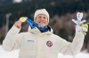 Gold medalist Johannes Hoesflot Klaebo, of Norway, poses on the podium of the cross-country skiing men's sprint classic at the 2026 Winter Olympics, in Tesero, Italy, Tuesday, Feb. 10, 2026. (AP Photo/Evgeniy Maloletka)
