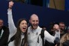 Italy's Amos Mosaner and Stefania Constantini celebrate after winning the bronze medal mixed doubles curling match against Britain, at the 2026 Winter Olympics, in Cortina D'Ampezzo, Italy, Tuesday, Feb. 10, 2026. (AP Photo/Misper Apawu)