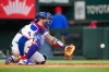 FILE - Texas Rangers catcher Jonah Heim warms up during the second inning of a baseball game against the Milwaukee Brewers, Sept. 8, 2025, in Arlington, Texas. (AP Photo/Julio Cortez, File)