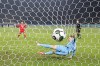 Freiburg's Yuito Suzuki, left, scores in the penalty shootout against Hertha Berlin goalkeeper Tjark Ernst in a German Cup quarterfinal soccer match between Hertha BSC Berlin and SC Freiburg in Berlin, Tuesday, Feb. 10, 2026. (Andreas Gora/dpa via AP)