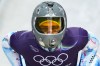 Ukraine's Vladyslav Heraskevych arrives at the finish during a men's skeleton training session at the 2026 Winter Olympics, in Cortina d'Ampezzo, Italy, Wednesday, Feb. 11, 2026. (AP Photo/Alessandra Tarantino)