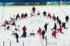 Canada's head coach Jon Cooper, lower right with arm raised, speaks to the team during men's ice hockey practice at the 2026 Winter Olympics, in Milan, Italy, Sunday, Feb. 8, 2026. (AP Photo/Carolyn Kaster)