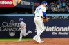 Toronto Blue Jays pitcher Shane Bieber (57) reacts as Los Angeles Dodgers catcher Will Smith (16) rounds the bases after hitting a solo home run during 11th inning Game 7 World Series playoff MLB baseball action in Toronto early Sunday, Nov. 2, 2025. THE CANADIAN PRESS/Frank Gunn