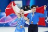 Piper Gilles and Paul Poirier of Team Canada celebrate their bronze medal in the Figure Skating Ice Dance competition during the 2026 Milan Cortina Winter Olympics in Milan, Italy on Wednesday, Feb. 11, 2026. THE CANADIAN PRESS/Nathan Denette