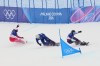 From left, Switzerland's Kalle Koblet, Britain's Huw Nightingale and Canada's Evan Bichon practice during a snowboard cross training session at the 2026 Winter Olympics, in Livigno, Italy, Friday, Feb. 6, 2026. (AP Photo/Lindsey Wasson)