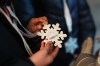 Children receive snowflake-shaped medals inspired by the 2026 Winter Olympics during an activity organized by a parish oratory connected to the Church of Santa Eufemia in Milan, Italy, Monday, Feb. 9, 2026. (AP Photo/María Teresa Hernandez)