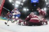 United States' Brock Nelson, left, scores his sides second goal past Latvia's goalkeeper Elvis Merzlikins during a preliminary round match of men's ice hockey between Latvia and the United States at the 2026 Winter Olympics, in Milan, Italy, Thursday, Feb. 12, 2026. (David W Cerny/Pool Photo via AP)