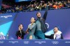 Laurence Fournier Beaudry and Guillaume Cizeron of France react to their scores that earned them the gold medal after competing during the ice dancing free skate in figure skating at the 2026 Winter Olympics, in Milan, Italy, Wednesday, Feb. 11, 2026. (AP Photo/Stephanie Scarbrough)