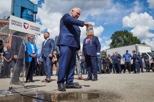 Ontario Premier Doug Ford empties a Crown Royal bottle of whisky at a press conference in Kitchener, Ont., on Tuesday, Sept. 2, 2025. Ford criticized the popular whisky's parent company, Diageo, for their plan to close one of their Ontario bottling plants in the coming months. THE CANADIAN PRESS/Sammy Kogan