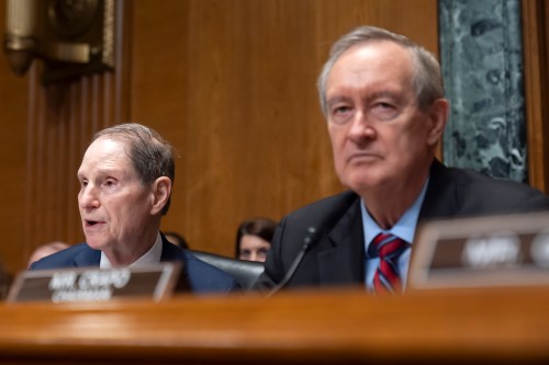 Ranking member Sen. Ron Wyden, D-Ore., left, speaks as committee chairman Sen. Mike Crapo, R-Idaho, listens during a hearing of the Senate Finance Committee on Capitol Hill in Washington on Thursday, Sept. 4, 2025. (AP Photo/Mark Schiefelbein)