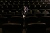 An employee cleans seats at a movie theatre as part of health and safety protocols put in place at Cineplex movie theatres due to the continued COVID19 pandemic, in Toronto, Tuesday, Oct. 6, 2020. THE CANADIAN PRESS/Chris Young