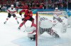 Canadian forward Connor McDavid (97) passes the puck in front of Swiss goalie Akira Schmid (40) at the 2026 Winter Olympics in Milan on Friday, Feb. 13, 2026. THE CANADIAN PRESS/Darryl Dyck
