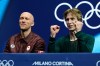 Stephen Gogolev of Canada, right, reacts to his scores after competing during the men's free skate program in figure skating while sitting next to choreographer Benoit Richaud, left, at the 2026 Winter Olympics, in Milan, Italy, Friday, Feb. 13, 2026. (AP Photo/Ashley Landis)