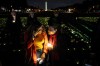 FILE - Madiha Maria, left, cries with Rana Abbas Taylor of Northville, Mich., who lost her only sister, brother-in-law and their three children to a drunk driver, during a candlelight vigil for people who had family members killed by drunk drivers, Tuesday, Nov. 19, 2024, on the National Mall, in Washington. (AP Photo/Jacquelyn Martin, File)