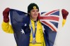 Silver medalist Australia's Scotty James holds an Australian flag after the men's snowboarding halfpipe finals at the 2026 Winter Olympics, in Livigno, Italy, Friday, Feb. 13, 2026. (AP Photo/Gregory Bull)