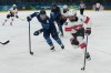 Switzerland's Kaleigh Quennec (8) skates with the puck as Finland's Jenni Hiirikoski (6) chases in the first during a preliminary round match of women's ice hockey at the 2026 Winter Olympics, in Milan, Italy, Tuesday, Feb. 10, 2026. (AP Photo/Carolyn Kaster)