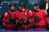 Canada's Blayre Turnbull, left, takes a spot on the bench with Brianne Jenner (19) and Sarah Nurse (20) after Turnbull scored a goal against Germany during the third period of a women's ice hockey quarterfinal match at the 2026 Winter Olympics, in Milan, Italy, Saturday, Feb. 14, 2026. (AP Photo/Carolyn Kaster)