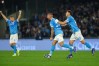Napoli's Leonardo Spinazzola, centre, celebrates after scoring his side's first goal during the Serie A soccer match between Napoli and Roma in Naples, Italy, Sunday, Feb. 15, 2026. (Alessandro Garofalo/LaPresse via AP)