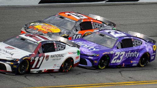 Denny Hamlin, (11), Bubba Wallace, (23) and Chase Briscoe, (19) run during the NASCAR Daytona 500 auto race at Daytona International Speedway, Sunday, Feb. 15, 2026, in Daytona Beach, Fla. (AP Photo/Mike Stewart)