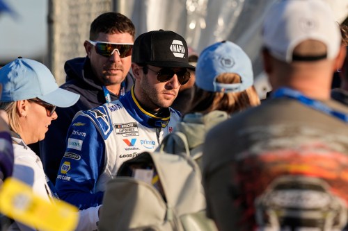 Chase Elliott signs autographs during practice at the NASCAR Daytona 500 auto races at Daytona International Speedway, Friday, Feb. 13, 2026, in Daytona Beach, Fla. (AP Photo/Mike Stewart)