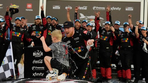 Tyler Reddick, (45) and his son Beau celebrate with the team after winning the NASCAR Daytona 500 auto race at Daytona International Speedway, Sunday, Feb. 15, 2026, in Daytona Beach, Fla. (AP Photo/Mike Stewart)