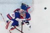 United States' goalkeeper Connor Hellebuyck makes a save during a preliminary round game of men's ice hockey between the United States and Germany at the 2026 Winter Olympics, in Milan, Italy, Sunday, Feb. 15, 2026. (AP Photo/Hassan Ammar)