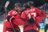 Canadian forward Nathan MacKinnon (right) celebrates with teammates Connor McDavid (97) and Macklin Celebrini (17) after scoring against Switzerland at the Olympics in Milan on Friday, Feb. 13, 2026. (AP Photo/Hassan Ammar)