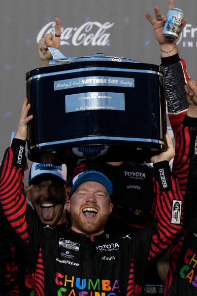 Tyler Reddick celebrates with the team his win of the NASCAR Daytona 500 auto race at Daytona International Speedway, Sunday, Feb. 15, 2026, in Daytona Beach, Fla. (AP Photo/Nigel Cook)