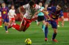 Girona's Vitor Reis is tacked by Barcelona's Eric Garcia during a Spanish La Liga soccer match between Girona and Barcelona in Girona, Spain, Monday, Feb. 16, 2026. (AP Photo/Joan Monfort)