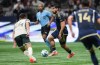 Vancouver Whitecaps' Brian White, back centre, moves the ball while being watched by Portland Timbers' David Ayala during the second half of an MLS soccer match, in Vancouver, on Wednesday, September 24, 2025. THE CANADIAN PRESS/Darryl Dyck