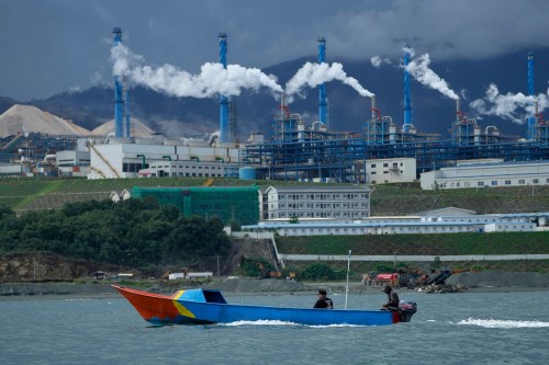 FILE - A boat cruises past a nickel processing plant at Indonesia Weda Bay Industrial Park in Central Halmahera, North Maluku province, Indonesia, June 8, 2024. (AP Photo/Achmad Ibrahim, File)