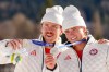 Ben Ogden and Gus Schumacher, of the United States, pose after winning the silver medal in the cross-country skiing men's team sprint free at the 2026 Winter Olympics, in Tesero, Italy, Wednesday, Feb. 18, 2026. (AP Photo/Kirsty Wigglesworth)