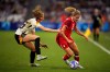 Germany's Janina Minge fights for the ball with Canada's Cloe Lacasse during a women's quarterfinal soccer match between Canada and Germany at the 2024 Summer Olympics, Saturday, Aug. 3, 2024, at Marseille Stadium in Marseille, France. (AP Photo/Daniel Cole)
