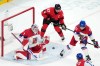 Czechia goalkeeper Lukas Dostal (1) blocks a shot as Czechia's Radim Simek (51) and Canada's Sidney Crosby (87) look for the rebound during the first period of a men's ice hockey quarterfinal game at the 2026 Winter Olympics, in Milan, Italy, Wednesday, Feb. 18, 2026. (AP Photo/Carolyn Kaster)