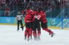 Team Canada players celebrate Canada's Mitch Marner's game-winning goal during overtime of a quarterfinal men's hockey game at the 2026 Winter Olympics, in Milan, on Wednesday, Feb. 18, 2026. THE CANADIAN PRESS/Darryl Dyck