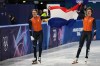Melle van 't Wout of the Netherlands wins silver, right, and Jens van 't Wout of the Netherlands wins bronze during the short track speed skating men's 500m at the 2026 Winter Olympics, in Milan, Italy, Wednesday, Feb. 18, 2026. (AP Photo/Stephanie Scarbrough)