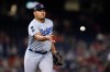 FILE - Los Angeles Dodgers relief pitcher Brusdar Graterol tosses the ball to third base during the ninth inning of a baseball game against the Washington Nationals, July 2, 2021, in Washington. (AP Photo/Julio Cortez, File)