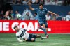 Vancouver Whitecaps' Tristan Blackmon (left) slide tackles Sporting Kansas City's Daniel Salloi (10) during the first half of an MLS soccer match in Vancouver, on Saturday, July 26, 2025. THE CANADIAN PRESS/Ethan Cairns