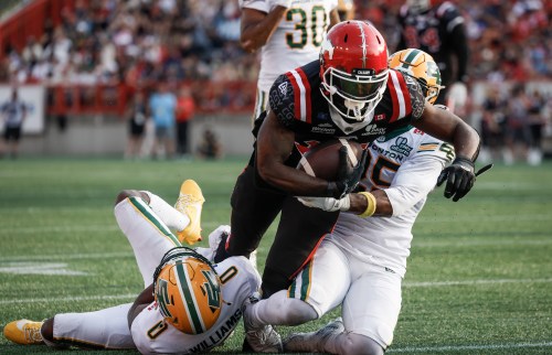 Edmonton Elks' Chelen Garnes, right, and Kobe Williams, left, tackle Calgary Stampeders' Dominique Rhymes during second half CFL football action in Calgary, Alta., Monday, Sept. 1, 2025. THE CANADIAN PRESS/Jeff McIntosh