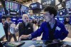 Specialists Meric Greenbaum, left, and Alex Weitzman work on the floor of the New York Stock Exchange, Friday, Feb. 20, 2026. (AP Photo/Richard Drew)