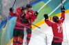 Canada's Nathan MacKinnon (29) celebrates with Sam Reinhart (13) and Macklin Celebrini (17) after MacKinnon scored a goal against Finland during the third period of a men's ice hockey semifinal game at the 2026 Winter Olympics in Milan, Italy, Friday, Feb. 20, 2026. (AP Photo/Carolyn Kaster)