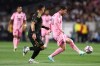 Inter Miami forward Lionel Messi, right, passes against Los Angeles FC midfielder Mark Delgado (8) dribbles the ball during the first half of an MLS soccer match, Saturday, Feb. 21, 2026, in Los Angeles, Calif. (AP Photo/Jessie Alcheh)